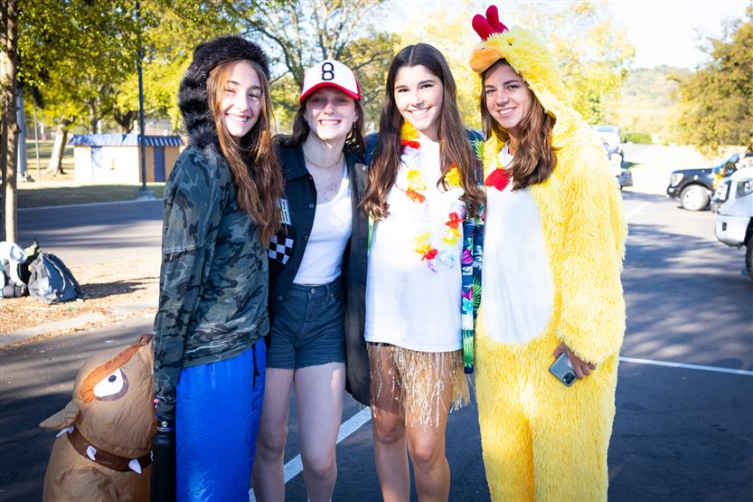 Several students smile before a homecoming parade
